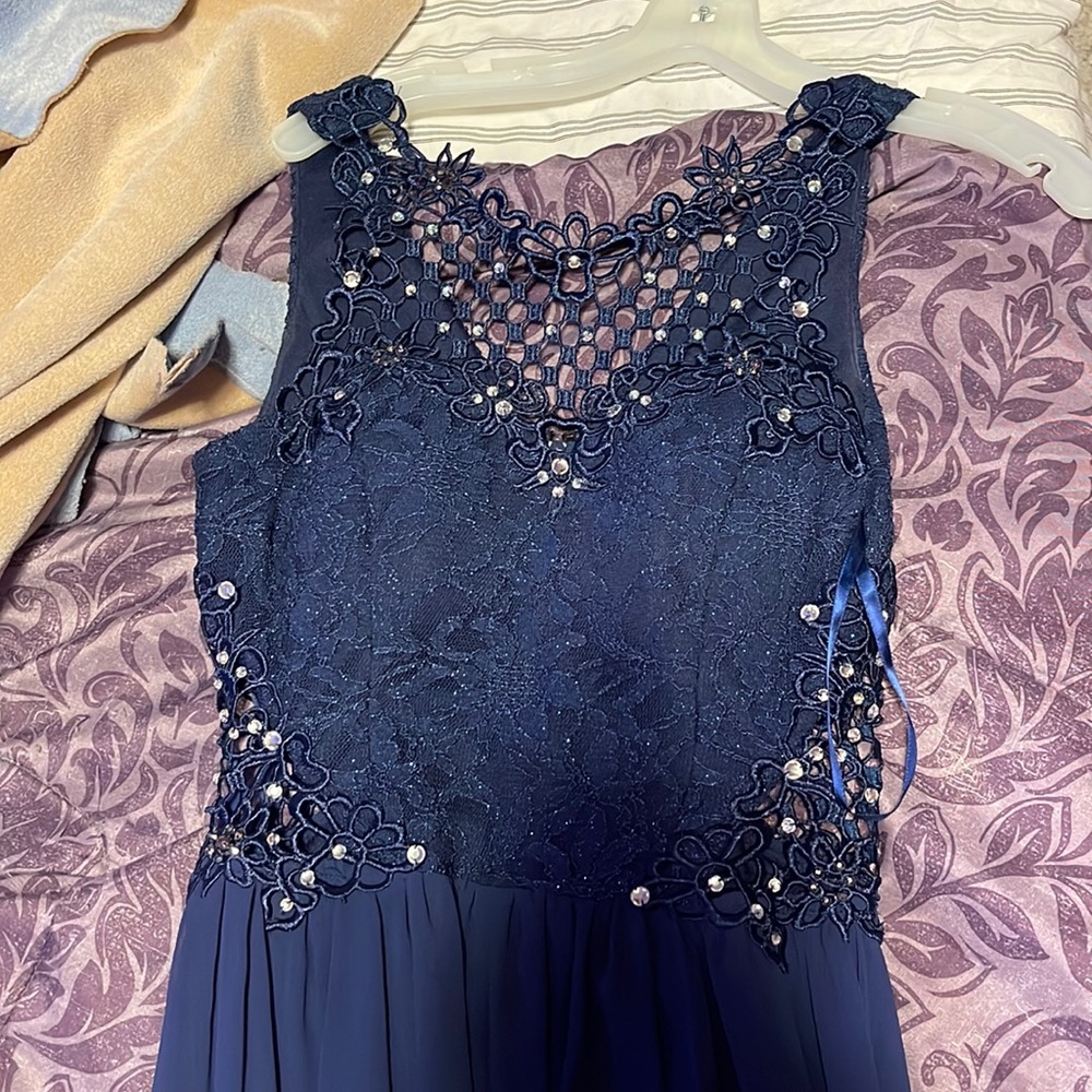 Navy blue with netting and gems on the chest area front and back. Only w…